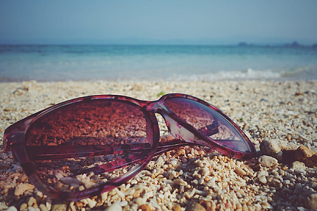 brown sunglasses on seashore thumbnail