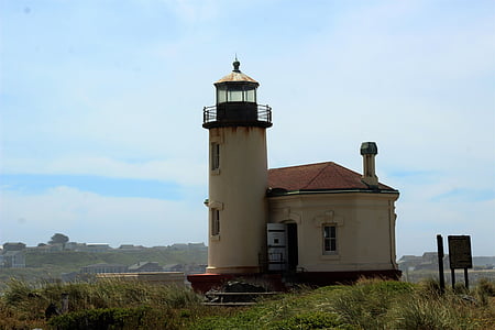 beige lighthouse tower across village at daytime thumbnail