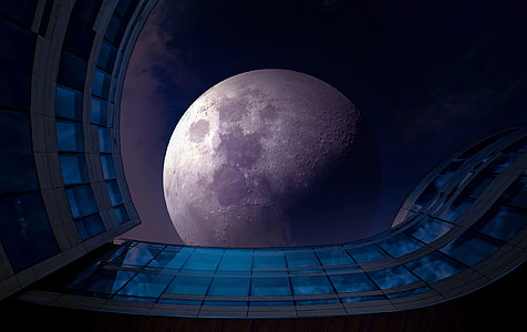 low angle photography of gray painted building under full moon thumbnail