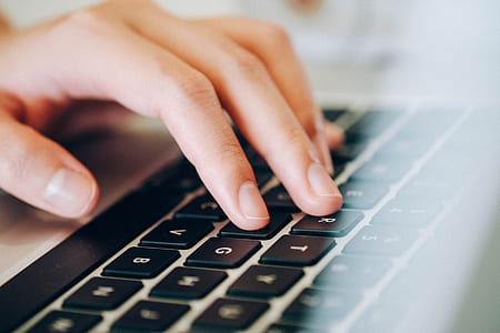 close-up photo of person manipulating on black and grey laptop thumbnail