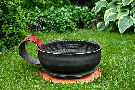 black tire teacup garden decor on lawn at daytime thumbnail