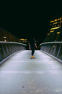male in blue 3/4 sleeved top and blue pants on skateboard thumbnail