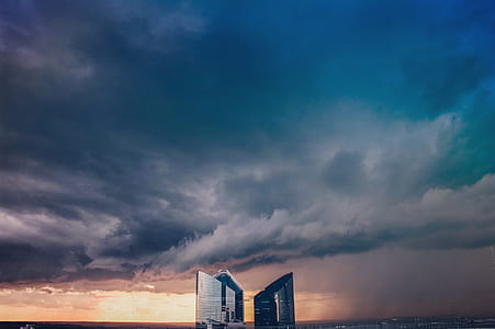 black and white concrete building under cloudy sky during sunset thumbnail