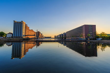 concrete buildings by the water at daytime thumbnail