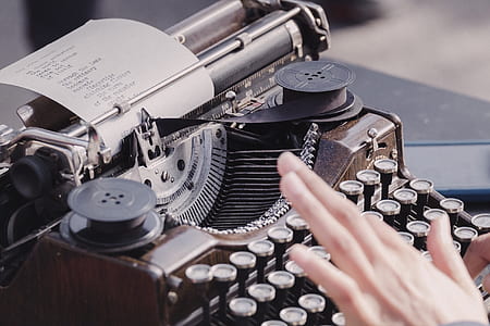 person typing on typewriter thumbnail