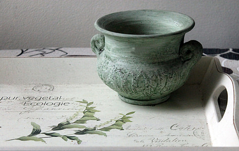 round gray clay pot on white and green wooden tray thumbnail