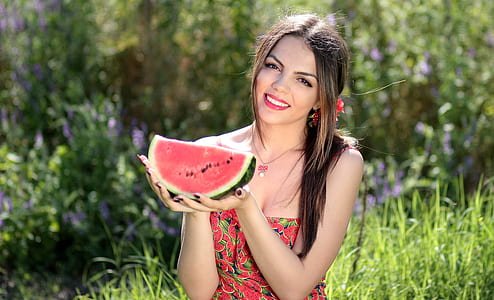 woman holding sliced watermelon at daytime thumbnail