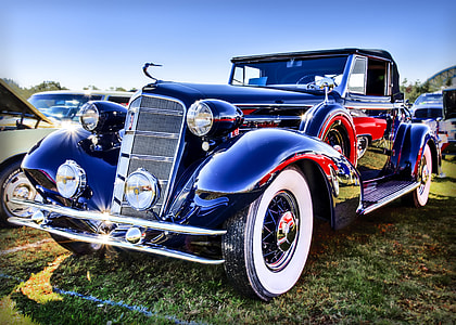 vintage black car on green grass thumbnail