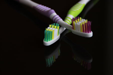 two toothbrushes on table thumbnail