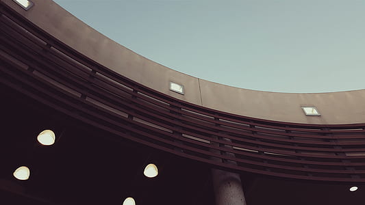 gray concrete building under gray sky low angle photography thumbnail