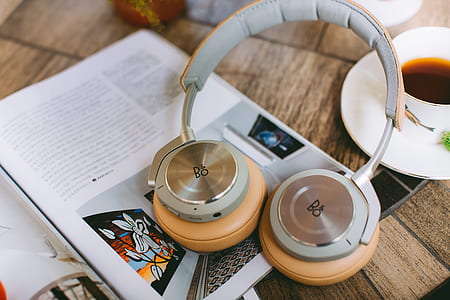 selective focus photography of B&O cordless headphones on magazine thumbnail