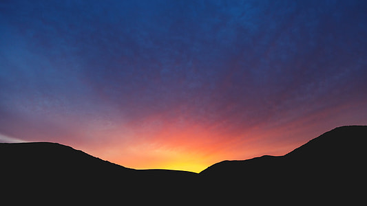 black mountain under blue cloudy sky during yellow sunset thumbnail