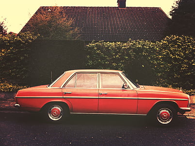 red sedan parked in front of house thumbnail