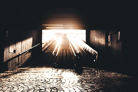 man standing at escalator during daytime thumbnail