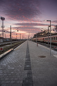 train beside brick pavement during sunset thumbnail