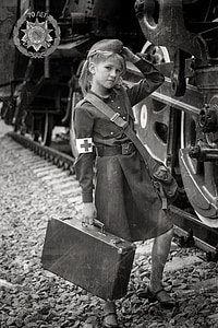 grayscale photo of girl min long-sleeved dress holding suitcase thumbnail
