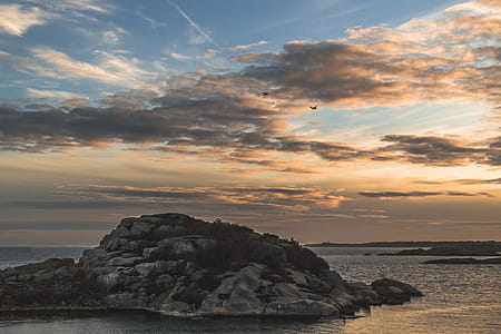 Island Surrounded by the Sea Under Stratus Clouds thumbnail