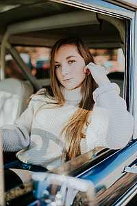 woman in white knit turtleneck sweater riding car thumbnail