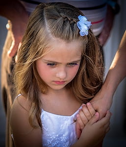girl facing down wearing white floral spaghetti-strap top thumbnail
