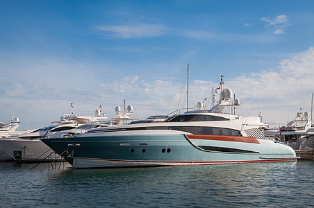 blue and white yacht on ocean during daytime thumbnail