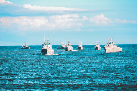 white ships on sea at daytime thumbnail