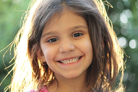 girl in pink top smiling thumbnail