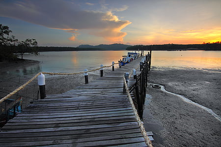 grey wooden dock near sea during thumbnail