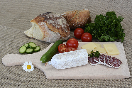 cucumber, tomato, cheese and vegetable on white wooden chopping board thumbnail