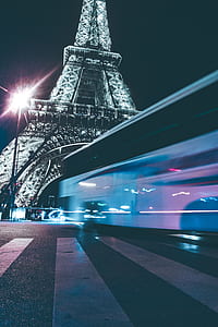 time-lapse photography of bus near Eiffel tower during night thumbnail