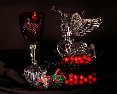 angel glass figurine beside clear wine glass thumbnail