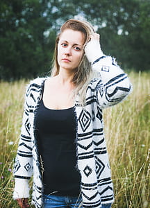 woman touching her hair with her left hand thumbnail