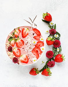 strawberry slices on round white ceramic bowl thumbnail
