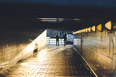 two person walking through tunnel during daytime thumbnail