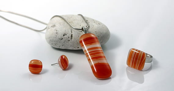 red-and-white gemstone jewelry set on white surface thumbnail
