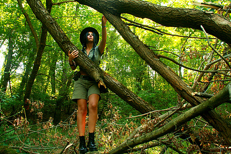 woman clinging on tree log thumbnail