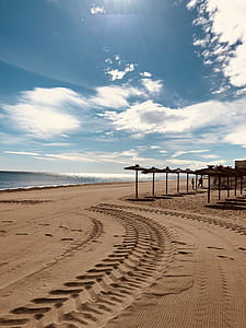 Brown Sand Near Seashore Under Cloudy Sky thumbnail
