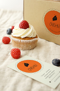 white icing-covered cupcake with raspberry thumbnail