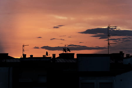 buildings under gray clouds during sunset thumbnail