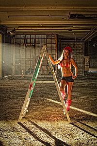woman wearing red bikini top standing on a-frame ladder thumbnail