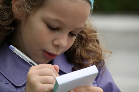 girl with purple leather collared jacket riding on white sticky note pad close-up photogoraphy thumbnail