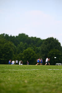 people gathering on grass field during daytime thumbnail