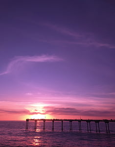 brown dock under blue sky during golden hour thumbnail
