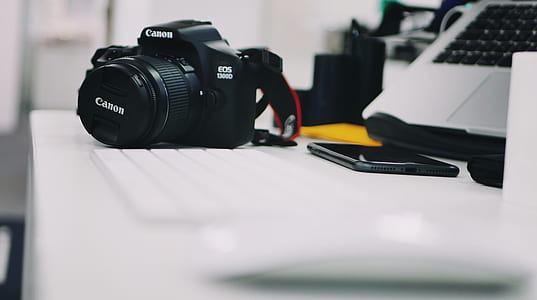 selective focus photography of black Canon DSLR camera thumbnail