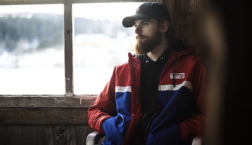 Man Wearing Blue, Red, and White Jacket thumbnail