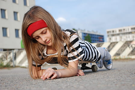 girl lying on skateboard on outdoors thumbnail