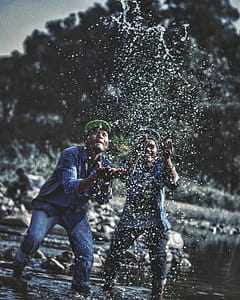 Two Men Playing With Water in Lake thumbnail