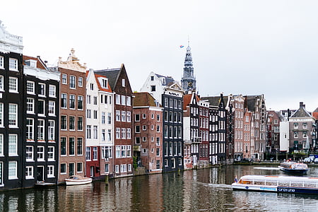 concrete buildings beside body of water thumbnail