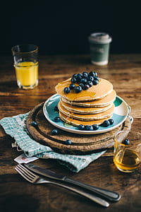pancake with black berries on plate in shallow photography thumbnail