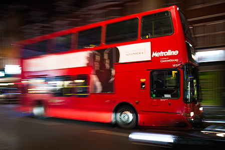 running red double decker bus along street thumbnail