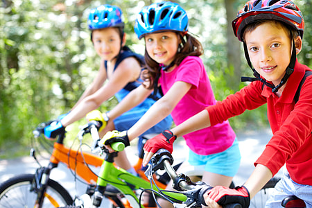 three girl's riding green and orange mountain bike photo during daytime thumbnail